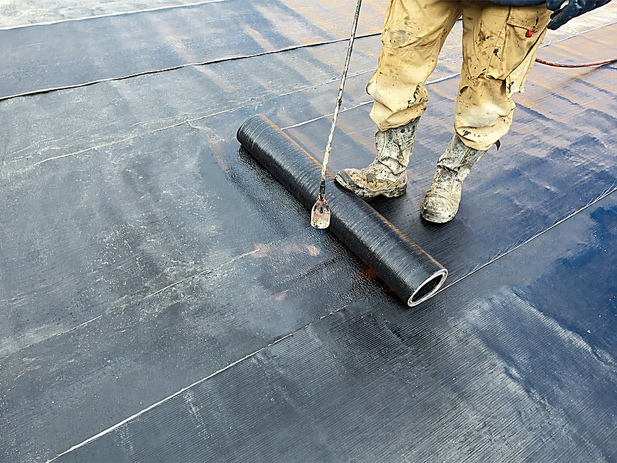 Roof waterproofing coating being applied